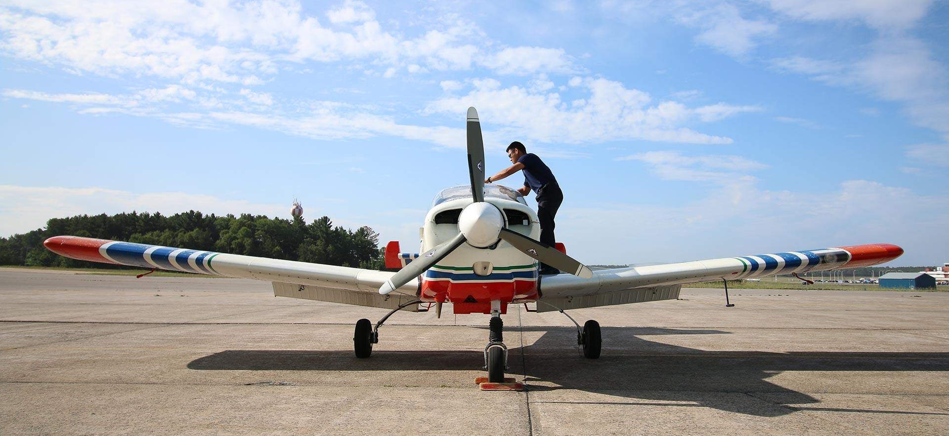 Student preparing о aircraft on runway for flight 