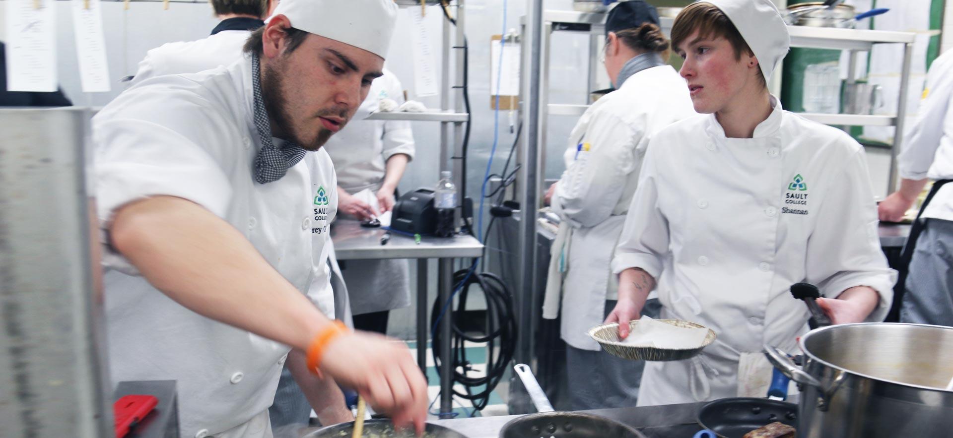 Busy culinary students work on an assignment in one of the о culinary kitchens.
