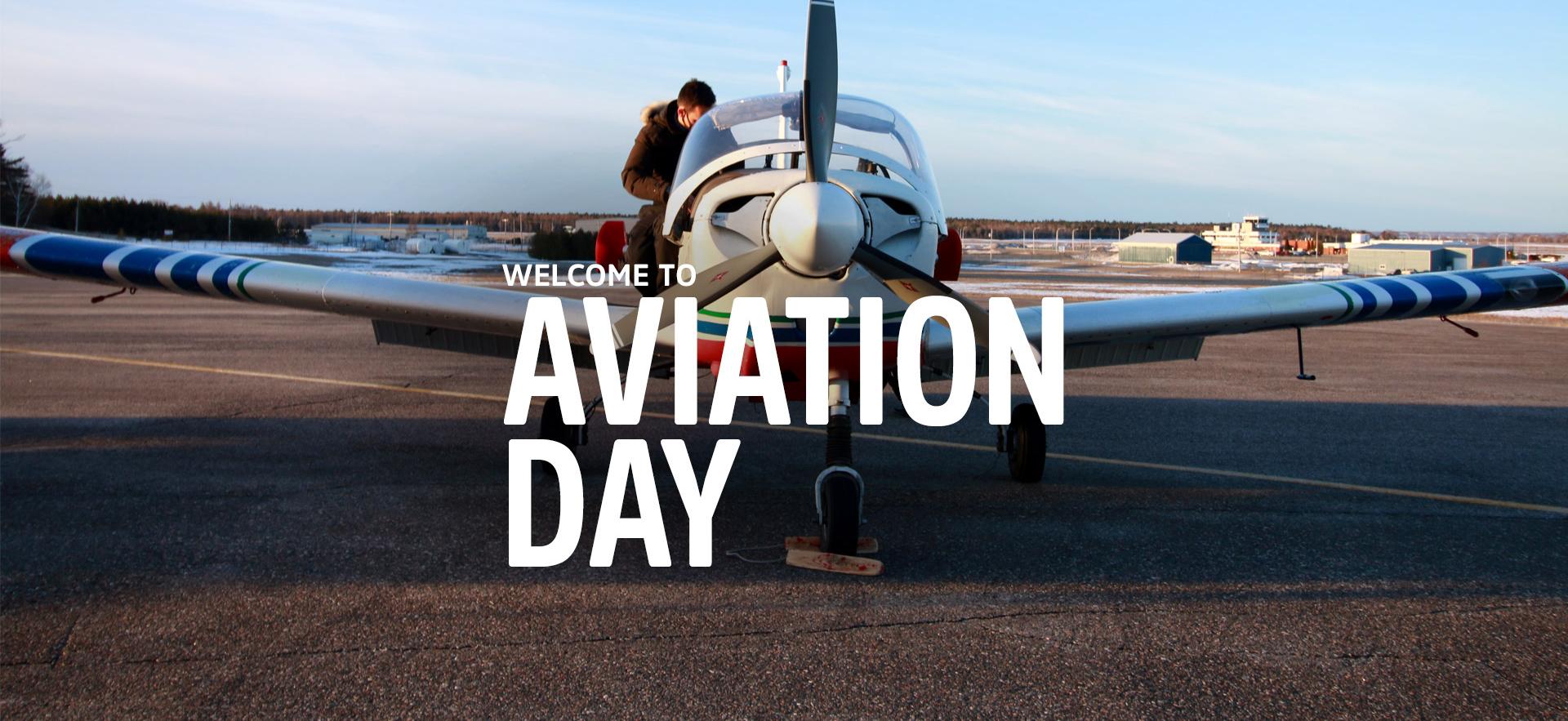 student on a plane landed at the о Hangar with white text overlay that says Welcome to Aviation Day